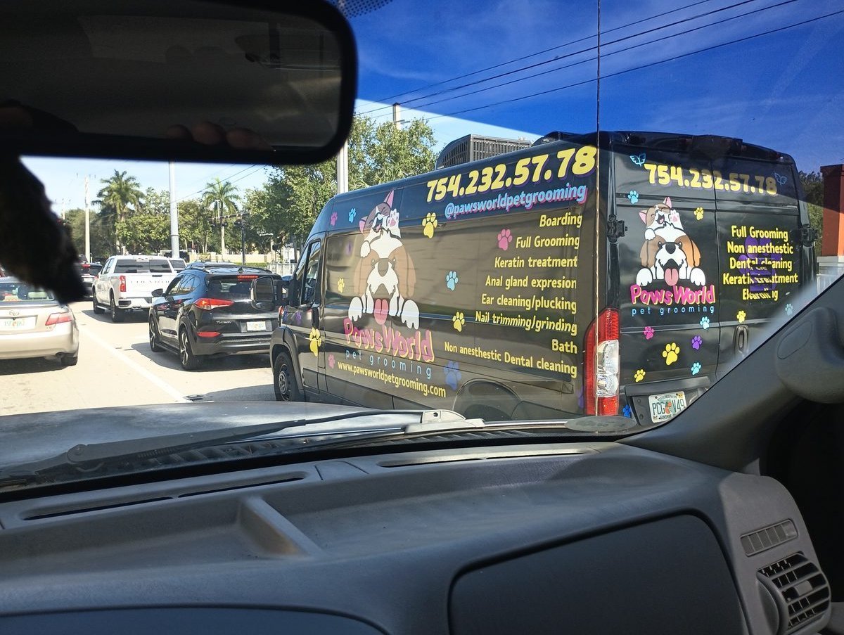 Paws World Pet Grooming fully wrapped mobile grooming van in traffic on State Road 84 Davie Florida