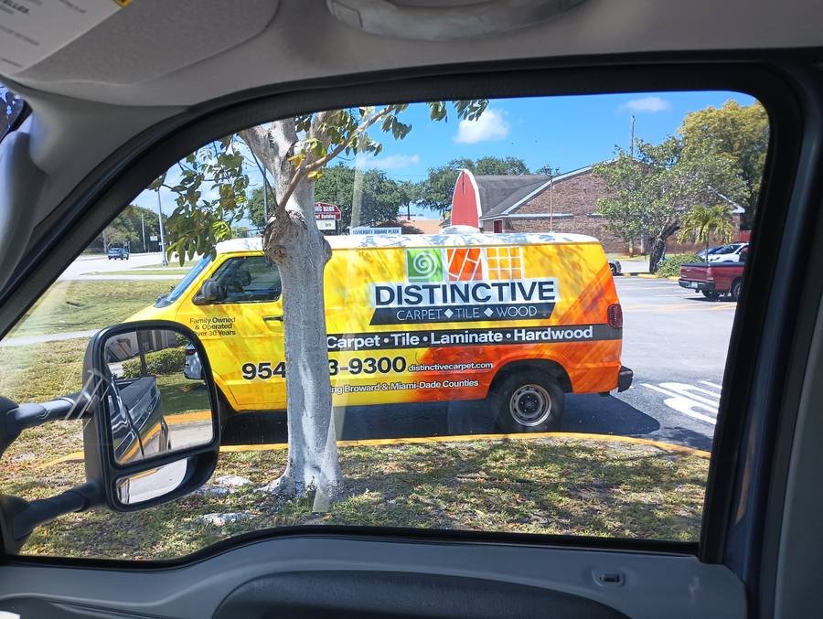 Distinctive Carpet van wrap spotted through window at intersection