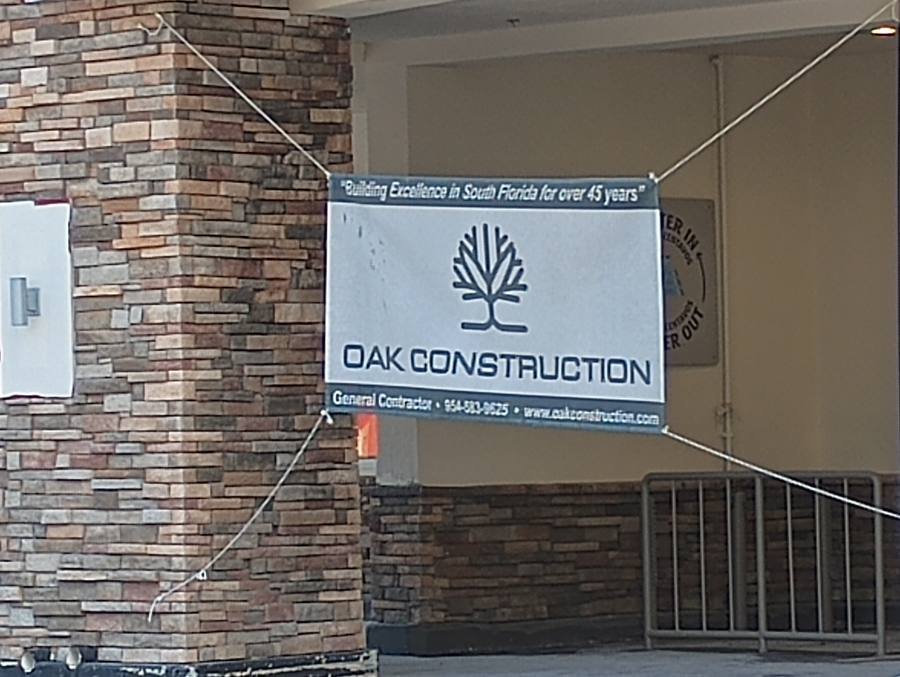 Oak Construction banner on building facade at job site